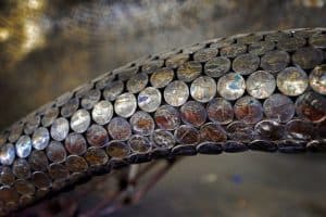 A detail of a curvaceous coin surface by Johnny Swing. Photo by Paul Specht